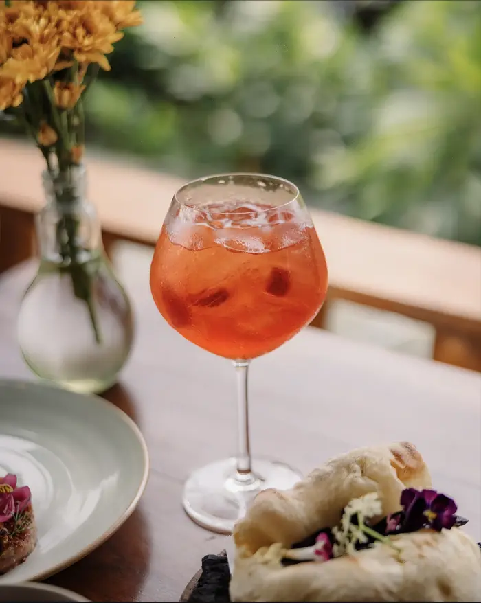 A cocktail on the terrace rail beside the flowers, Shaffa GastroBazar, Balangan, Bukit
