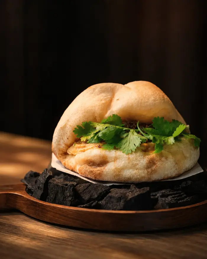 A filled bun served on charcoal, Shaffa GastroBazar, Balangan, Bukit