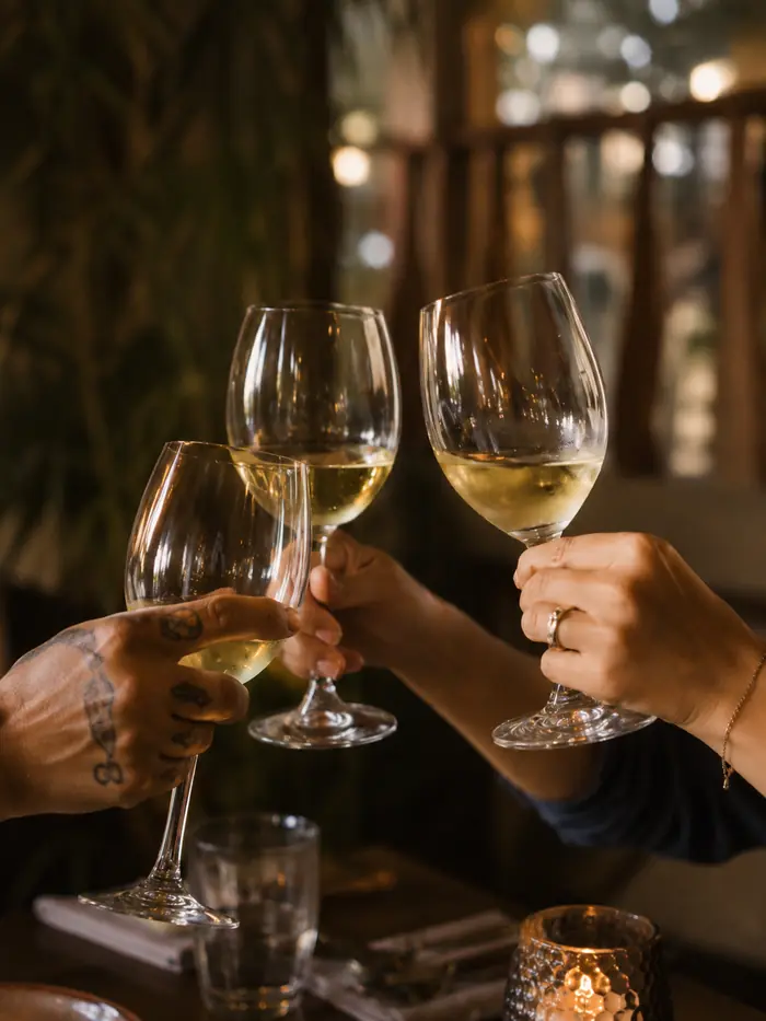 Glasses of white wine touching at the evening table, Shaffa GastroBazar, Balangan, Bukit