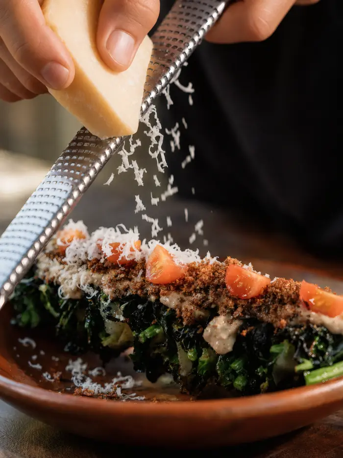 Parmesan grated over a dish of greens, Shaffa GastroBazar, Balangan, Bukit