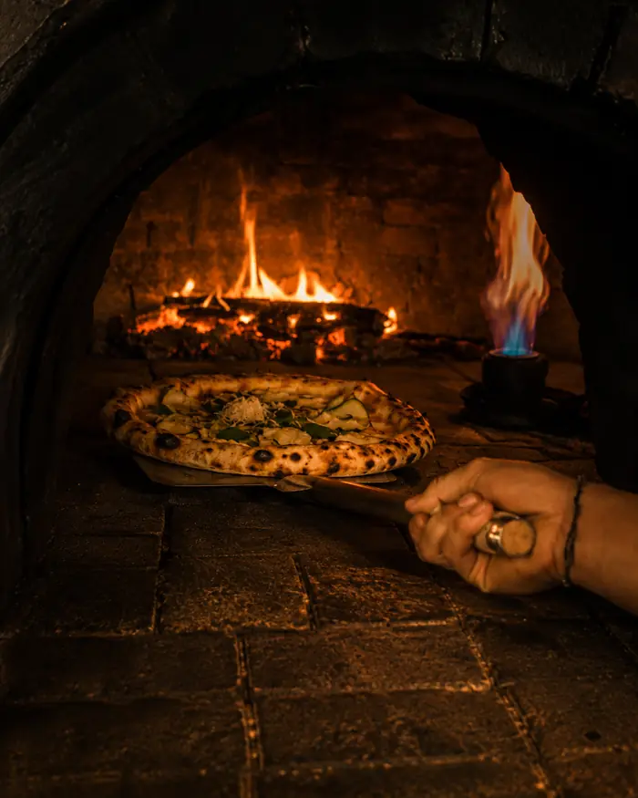 Pizza coming off the stone in the wood-fired oven, Shaffa GastroBazar, Balangan, Bukit
