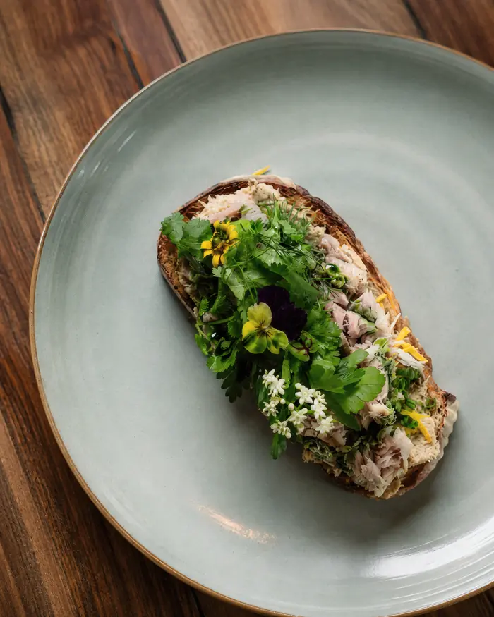 Toast with herbs and flowers on a pale plate, Shaffa GastroBazar, Balangan, Bukit